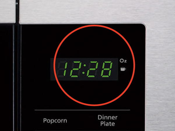 A control panel on a small microwave oven. Text reads: Digital display. 