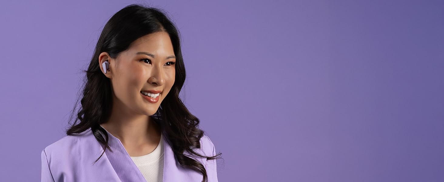 Woman wearing go pods in front of a monochrome purple background