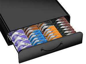 Black storage drawer containing neatly organized rows of colorful coffee pods. Drawer appears to be a specialized organizer for single-serve coffee capsules.