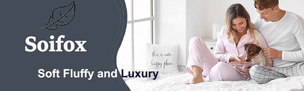 a woman sitting on a bed with pillows and a pillow