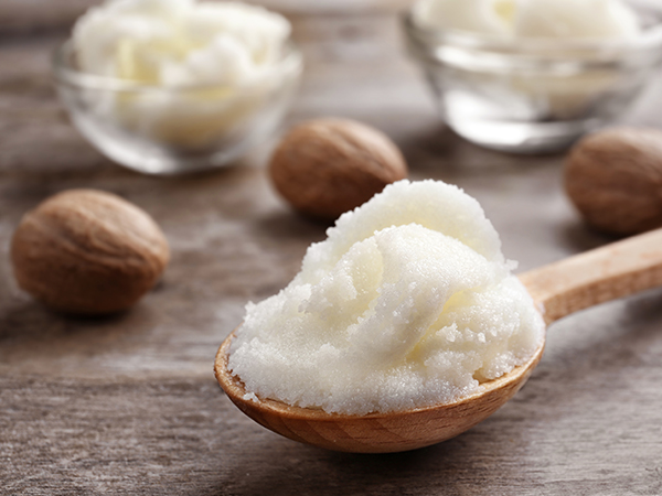Shea butter in a wooden spoon