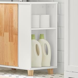 a white bathroom cabinet with two bottles of toilet paper and a wooden shelf.