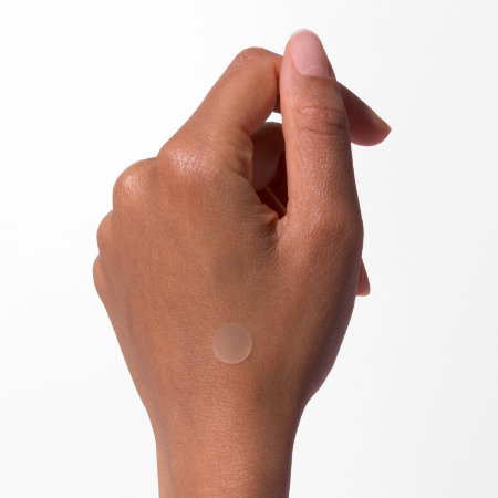 Sequential images showing application of a clear round adhesive patch to skin.