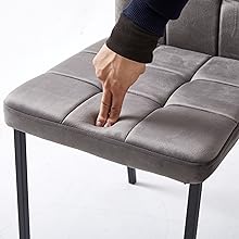 Close-up sequence showing gray upholstered furniture surface being pressed to demonstrate cushioning or adjustment feature.