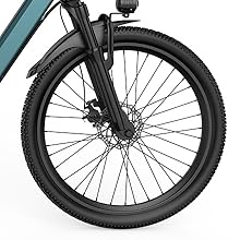 Close-up of black front bicycle wheel with disc brake system and thick tire mounted on dark teal frame.