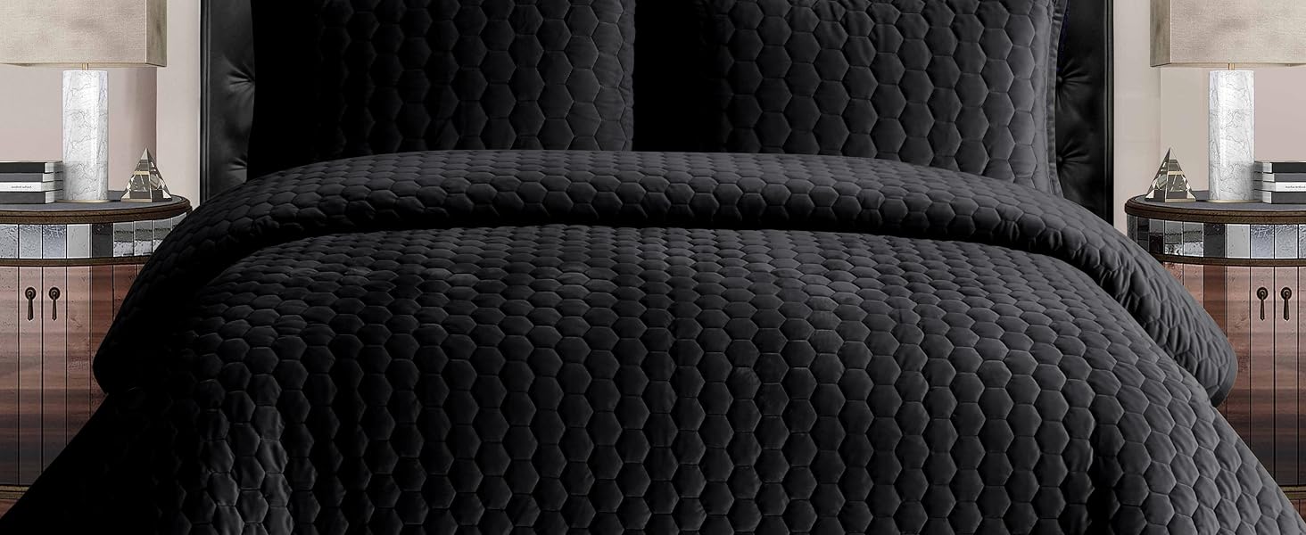 “Tribeca Living velvet comforter featuring a soft, plush texture and elegant sheen