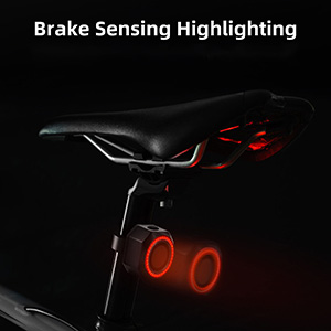 Bicycle seat and frame in dark lighting, showcasing red illuminated circles labeled as 'Brake Sensing Highlighting' for safety.