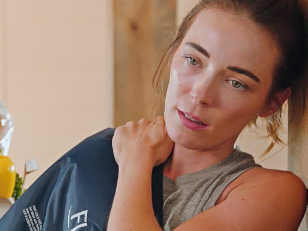 Woman with FlexiKold gel cold pack on shoulder