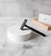 Double Edge Razor Leaning On White Block
