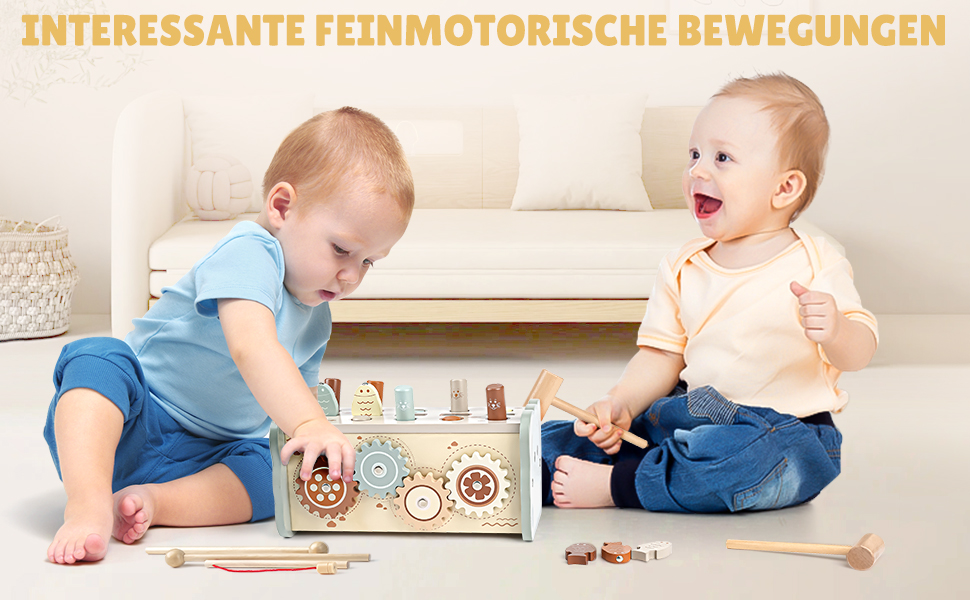 Two infants playing with a wooden toy box featuring gears and mechanisms. The box is designed to promote fine motor skill development.