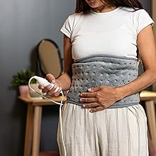 Person wearing a cream-colored dress against a dark wooden table surface, shown from torso down. Multiple views demonstrate the fabric's drape and texture.