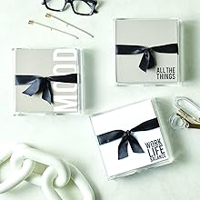 three loose leaf note pad squares nicely wrapped on an office desk