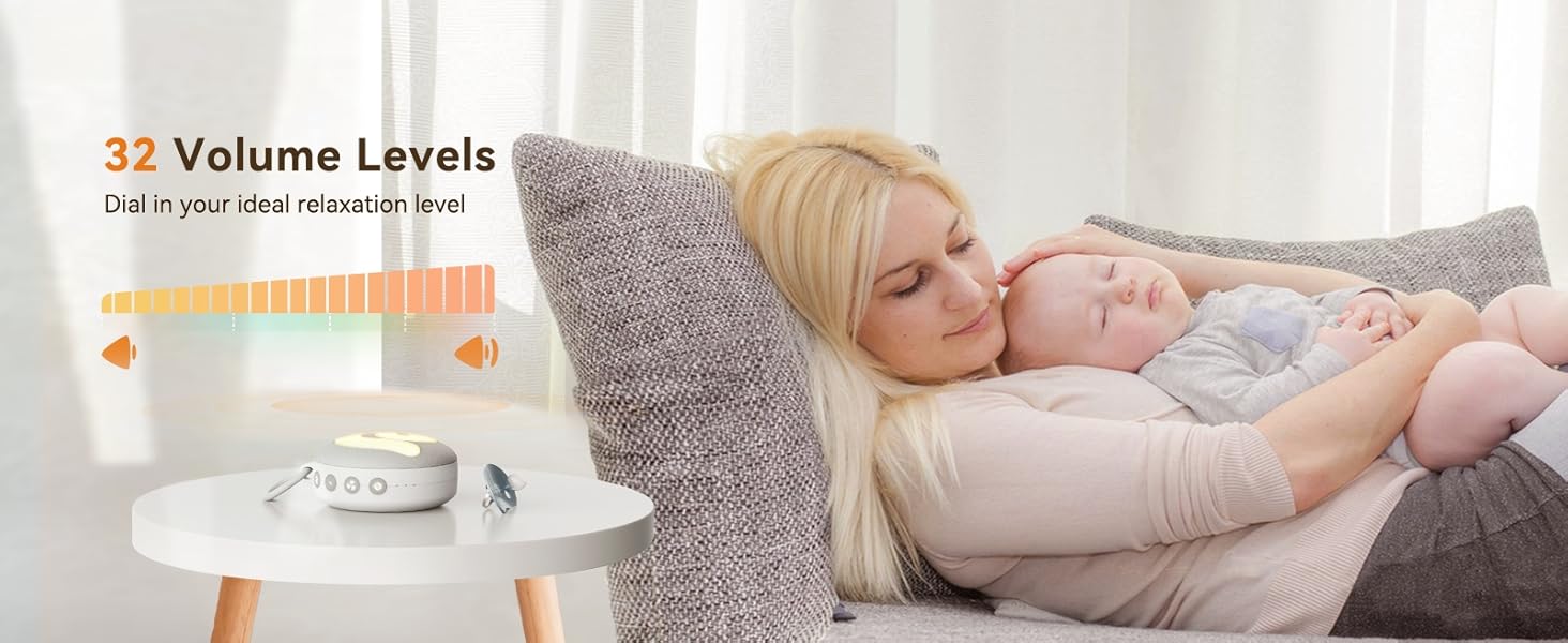 Baby monitor on side table with 32 volume levels displayed. Device shows orange volume bar and text indicating volume control feature.