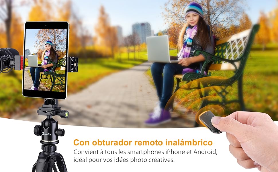 una niña sentada en un banco con un celular y un celular.