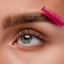 castor oil being applied to eyebrows and eye lashes