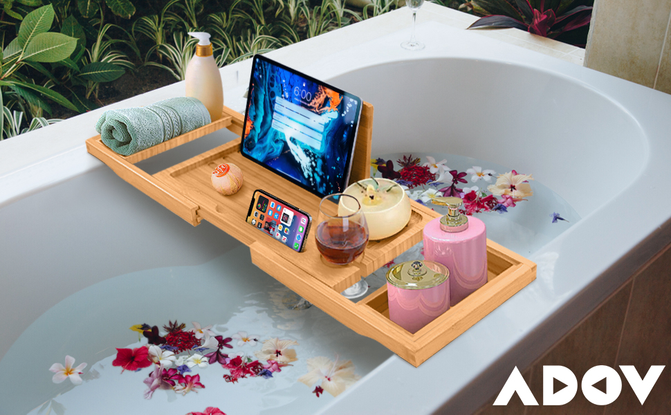 a bath tray with a tablet and a phone on it