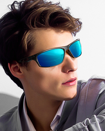 Sunglasses with rectangular blue-tinted lenses and dark frames, worn by a person with short, styled hair against a white background.