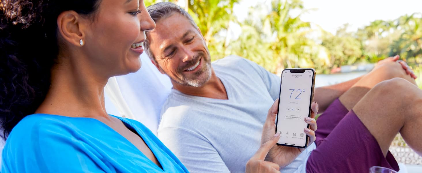 Woman using the Honeywell Home app while relaxing outside