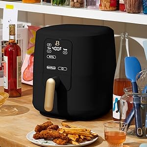 Modern black air fryer with a polished golden handle