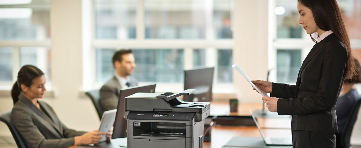 Woman in corporate office reviewing documents printed from MFC-L5705DW black & white laser printer