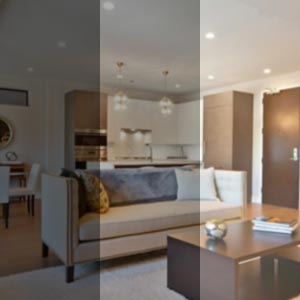 Innenaufnahmen eines modernen Apartments mit minimalistischer Küche und Wohnräumen mit weißen Schränken und integrierter Beleuchtung.