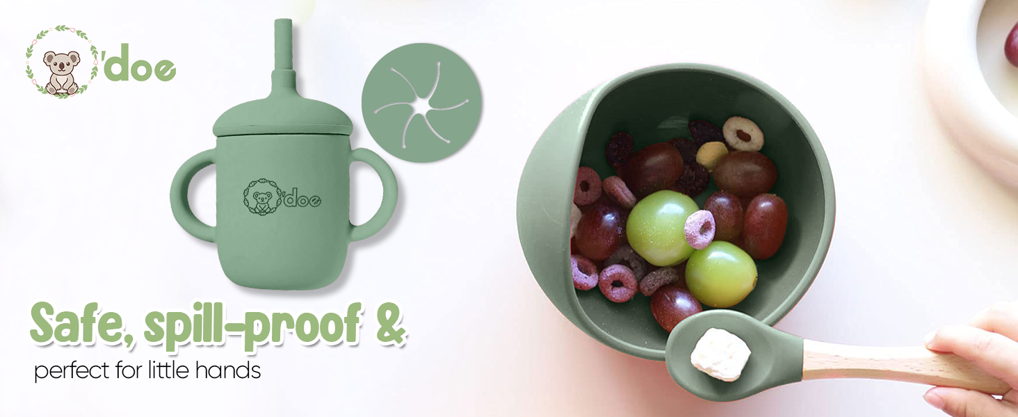 Green sippy cup with handles and straw lid, shown filled with fruit. Product emphasizes safety and spill-proof design for young children.