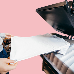 person using heat press with white shirt