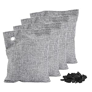 Four Gray Charcoal Bags with Pile of Bamboo Charcoal Front View
