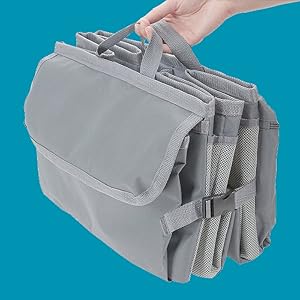 hand holding the folded high road trunk organizer for storage