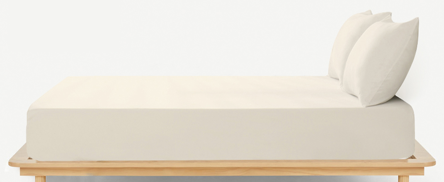 Modern minimalist daybed or chaise lounge with cream cushions on a light wooden platform base, photographed against white background.