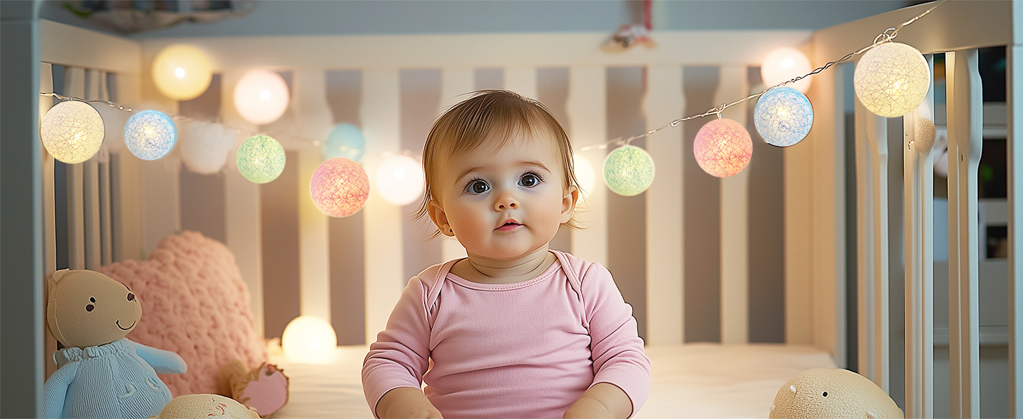 a baby in a crib with colorful lights.