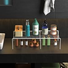 Organized bar caddy holding various bottles and containers on a dark surface, with metal rack system for storage.