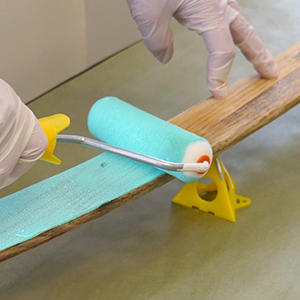Using a dense foam roller to apply paint over cured, sanded TotalBoat Penetrating Epoxy sealer