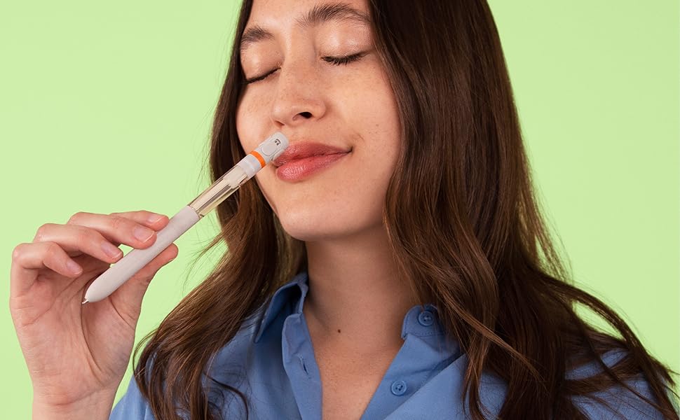 image of a woman sniffing the pen