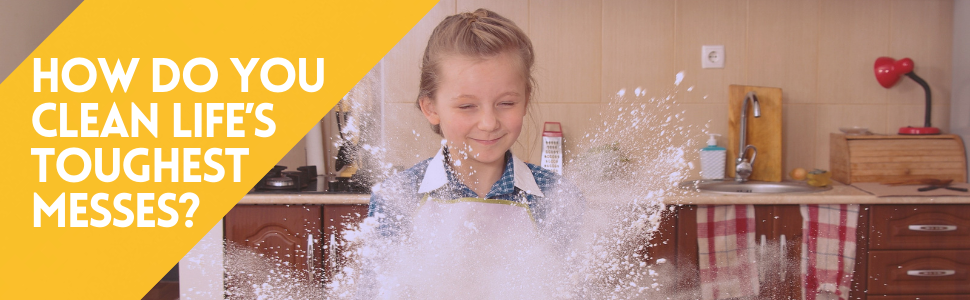 messy girl playing with baking flour on a kitchen counter. Baking flour explodes everywhere