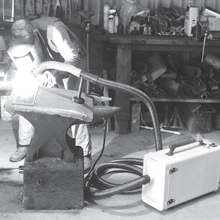 An extractor pulls away fume as a welder works with a torch