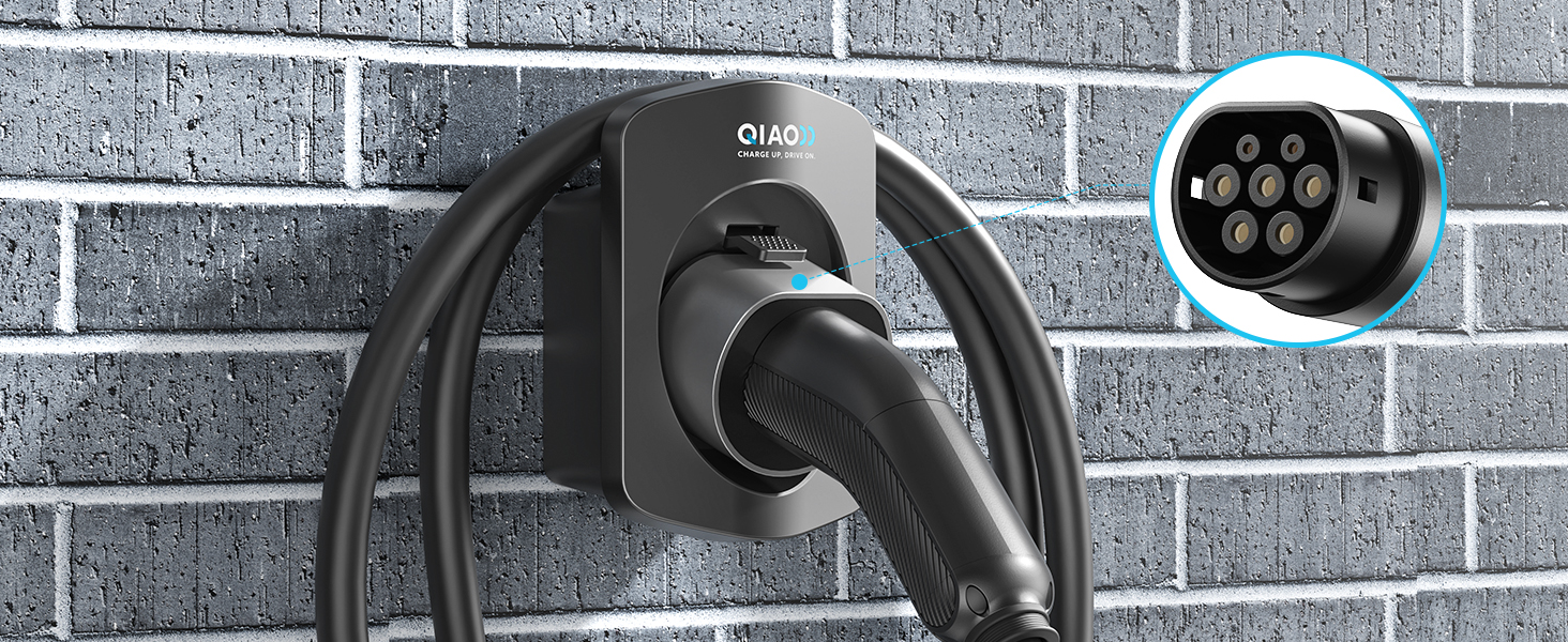 Electric vehicle charging station with black cord and plug mounted on a brick wall. Circular connector with multiple pins visible.