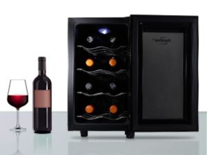 Thermoelectric wine cooler filled with bottles of red and white wine a glass of red wine beside it
