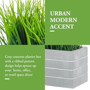 faux grass plant potted in cement planter