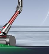 Same vacuum mechanism illustration from different angle, showing red handle component and power cord interaction with surface.
