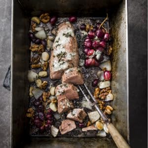 SHEET PAN PORK TENDERLOIN WITH GRAPES, WALNUTS, AND BLUE CHEESE with a pronged fork.