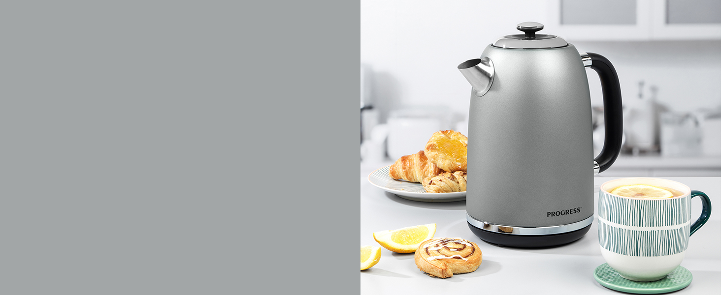 shimmer silver toaster wth toast and cup of tea next to kettle