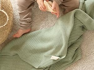 small kid with the roman green ribbed blanket