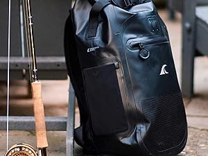 Breakwater Supply Meanhigh Dry Bag Backpack next to Fly Fishing Rod