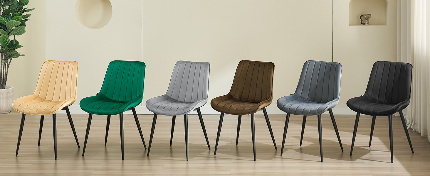 Six upholstered dining chairs in different colors: beige, green, light gray, brown, dark gray, and black. Chairs feature vertical quilted backs and metal legs.