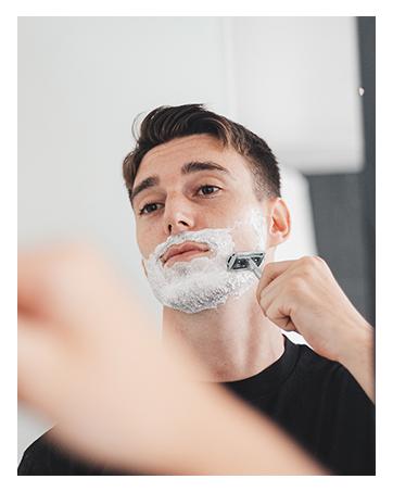Man Shaving With Safety Razor