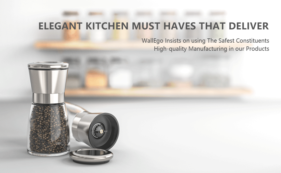 Two stainless steel salt and pepper grinders on a counter. Text above promotes 'Elegant Kitchen Must Haves' and manufacturing quality.