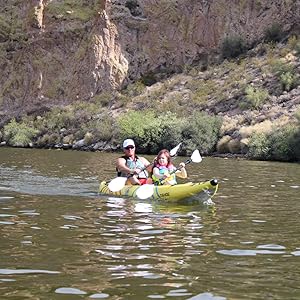 A man and daughter paddling the Buoy Watersports Tandem Tahoe Kayak on a lake