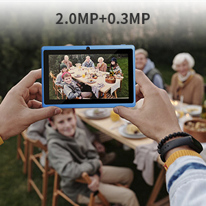 a person taking a picture of a family at a table