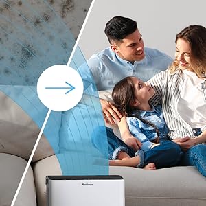 a family sitting on a couch with a laptop, a speaker, and a speaker in the background.